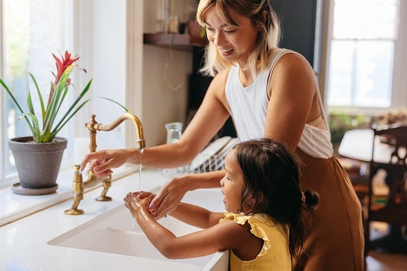 Mother and daughter washing hands