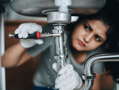 Cropped shot of an Asian woman repairing a sink leak