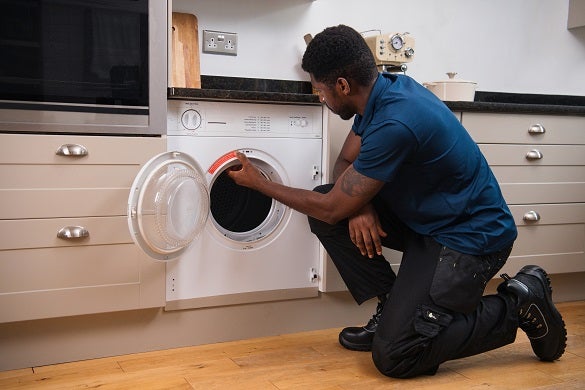 Domestic & General engineer repairing a tumble dryer