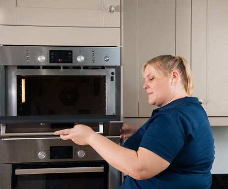 D&G engineer inspecting a gas cooker