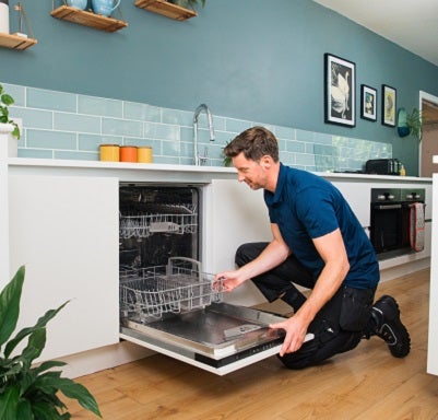 Female engineer fixing a washing machine